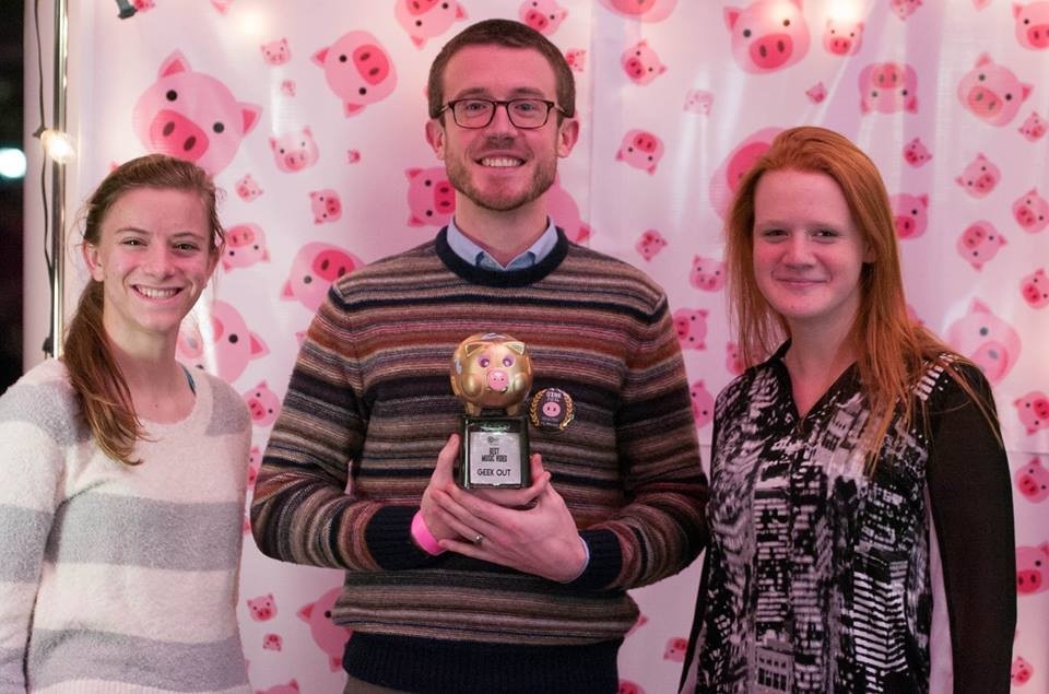 Image of one male and two female OINK film festival participants smiling with a trophy.