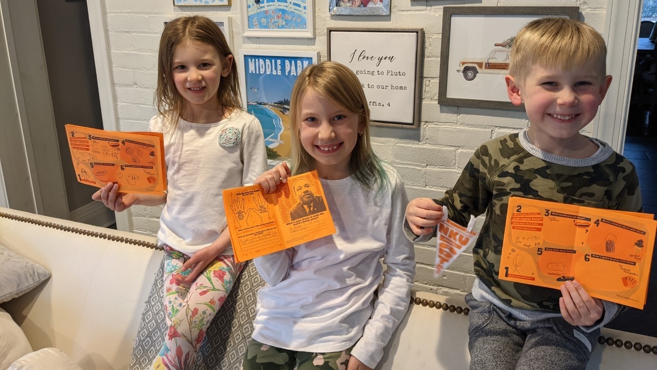 Kids holding up pennants