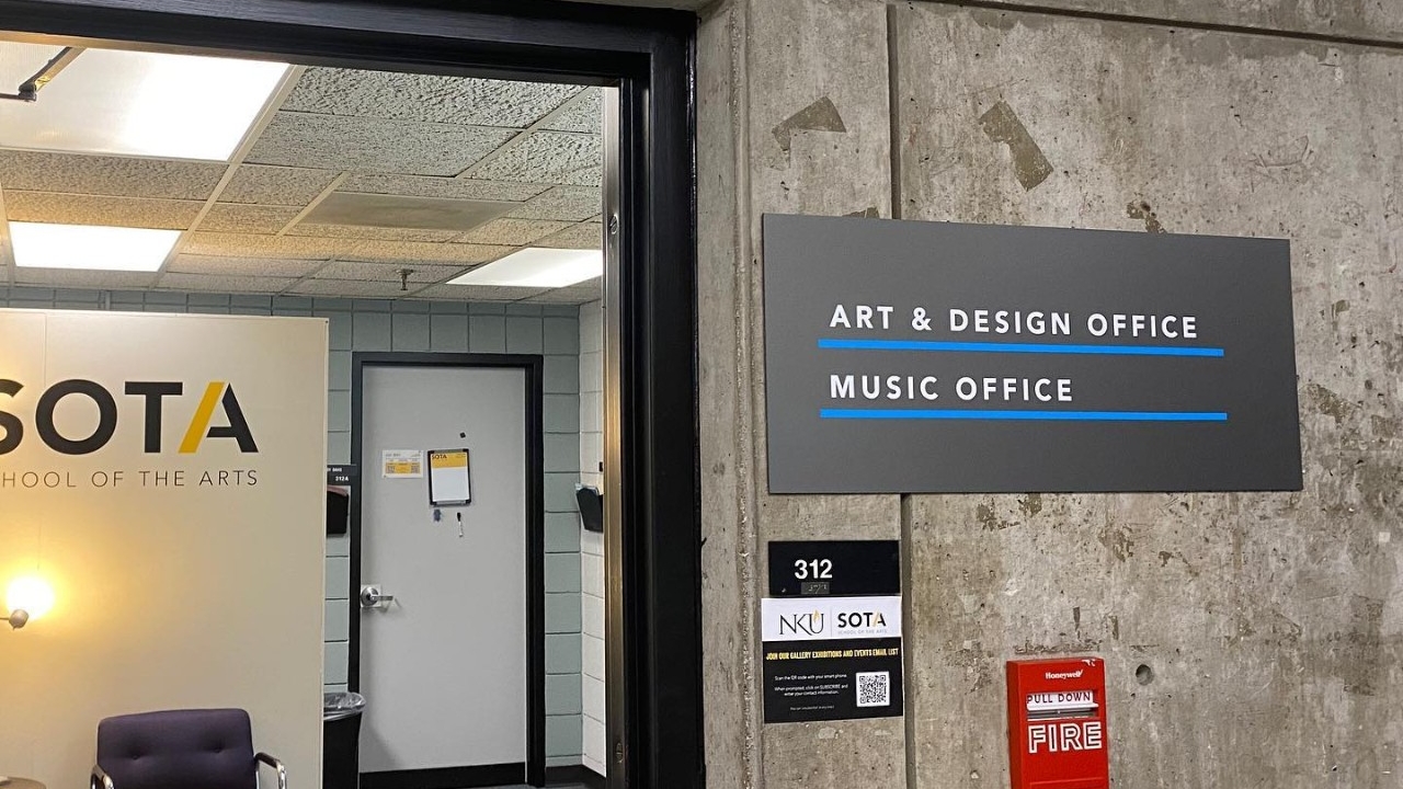 Artist in front of paint background