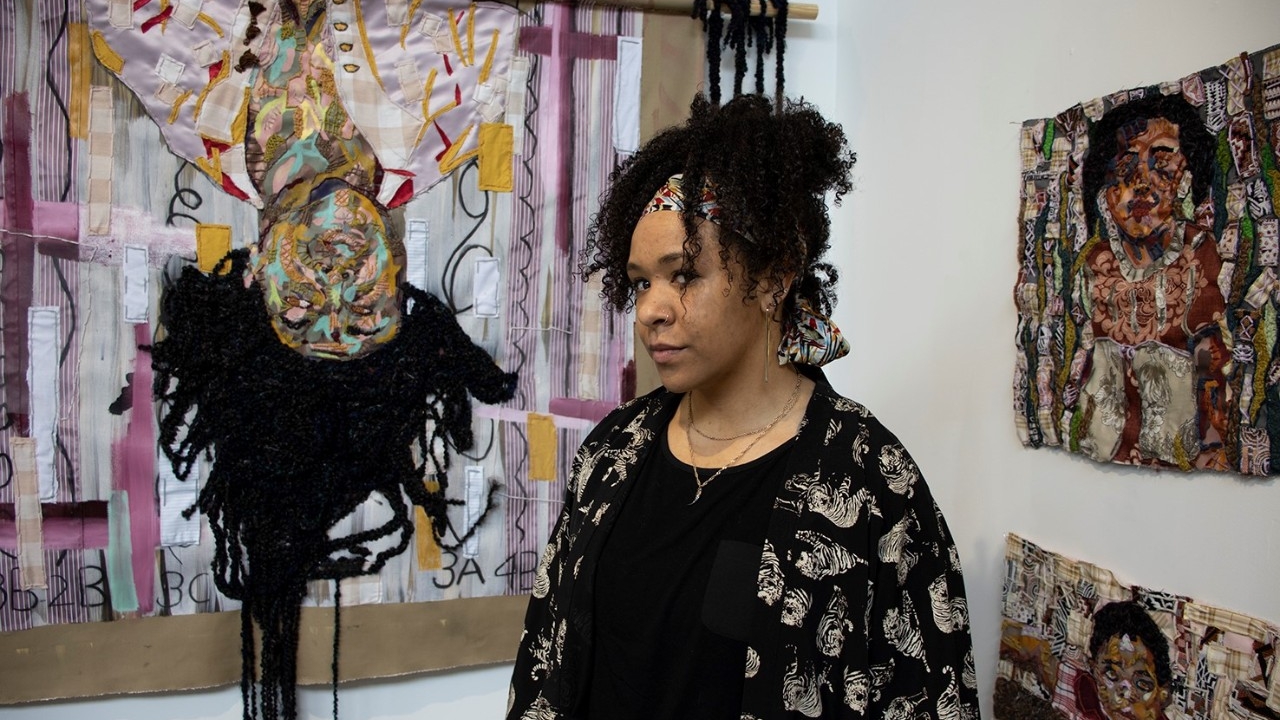 Artist in front of paint background