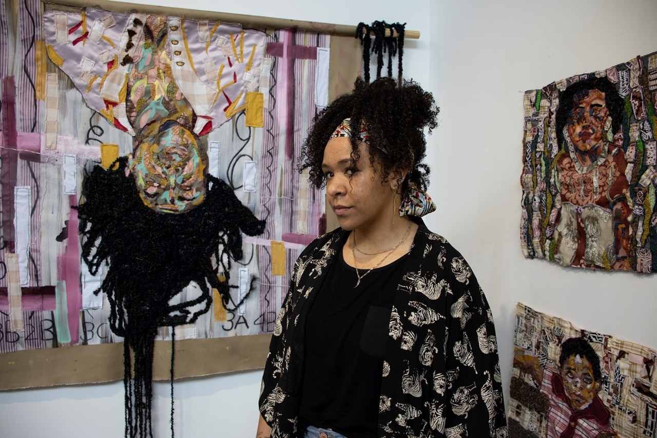 Artist in front of painted background