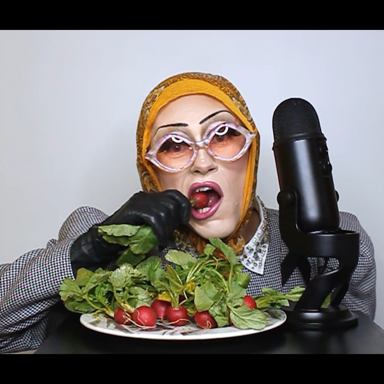 ASMR artist eating in front of microphone