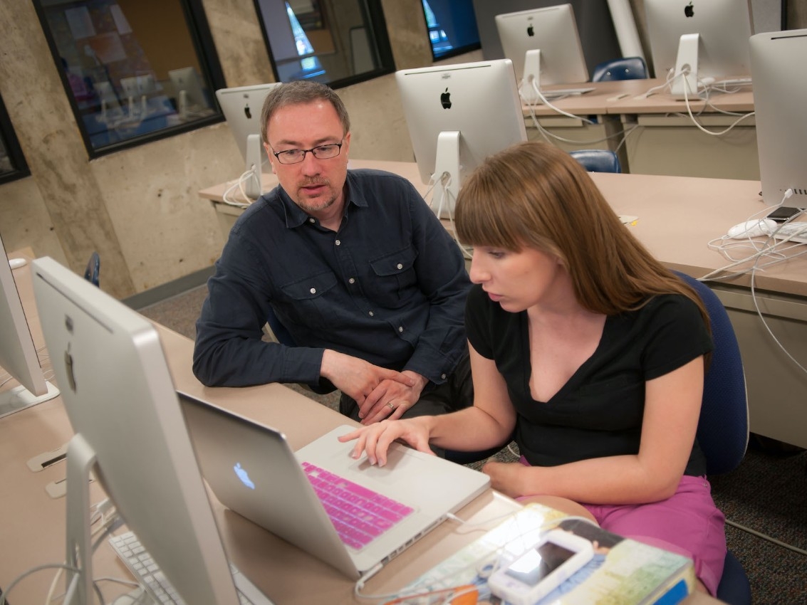 Student working on campus stairs
