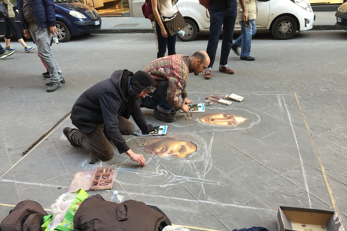 students drawing detail figures using sidewalk chalk