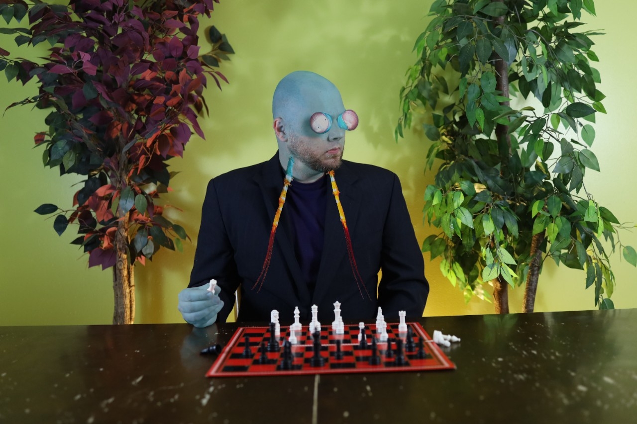 blue bug man playing chess