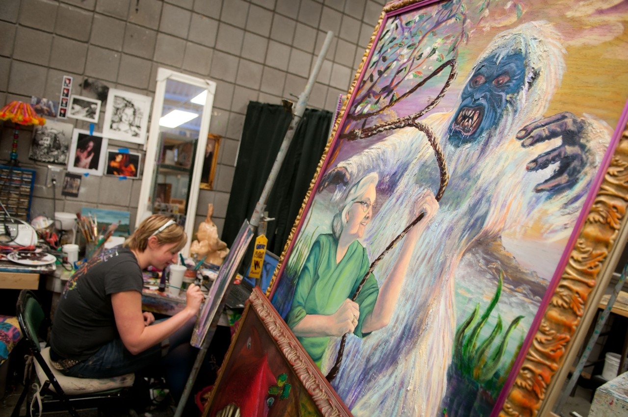 older lady lassoing a white haired monster 