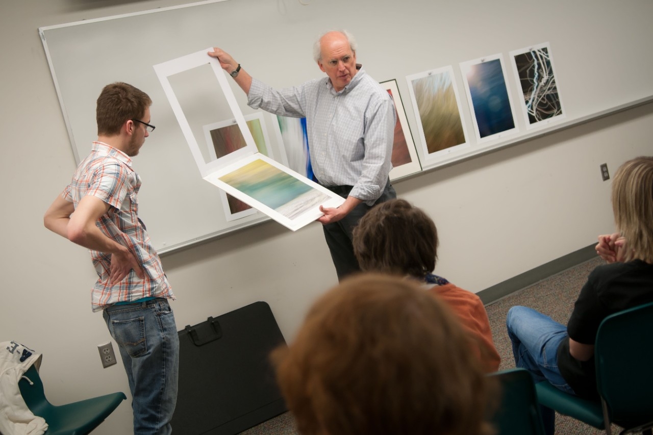 Teacher showing students photography examples