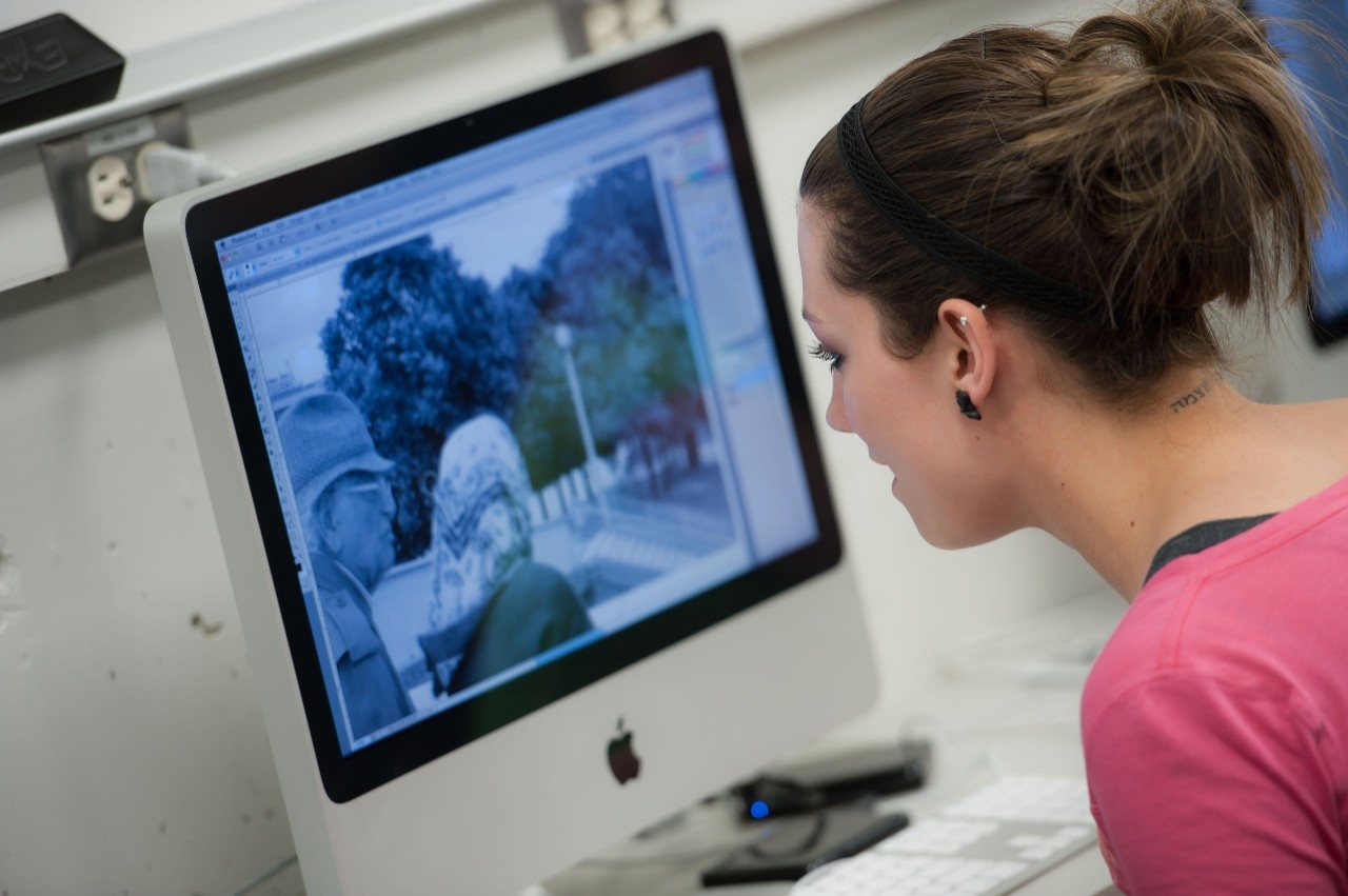 girl editing a photo on an apple computer