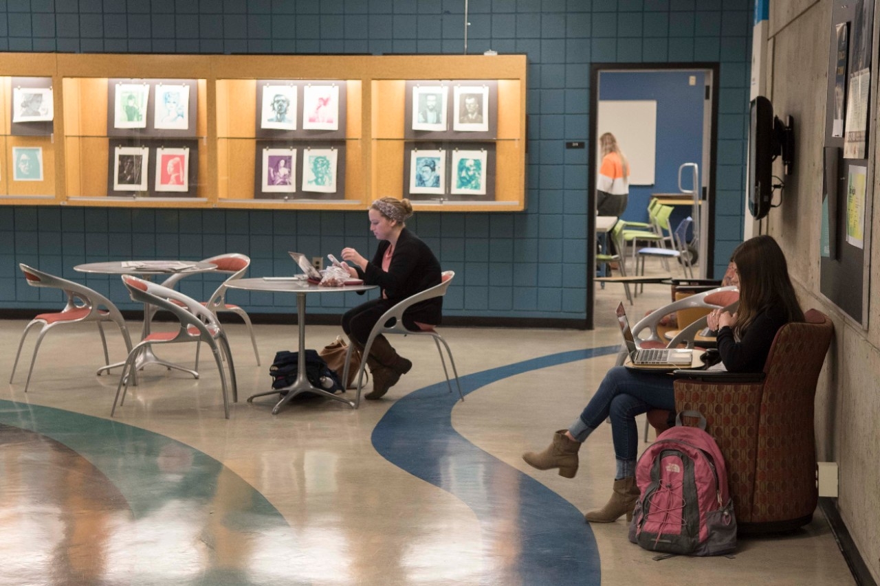 Students sitting in the SOTA builidng Lobby 