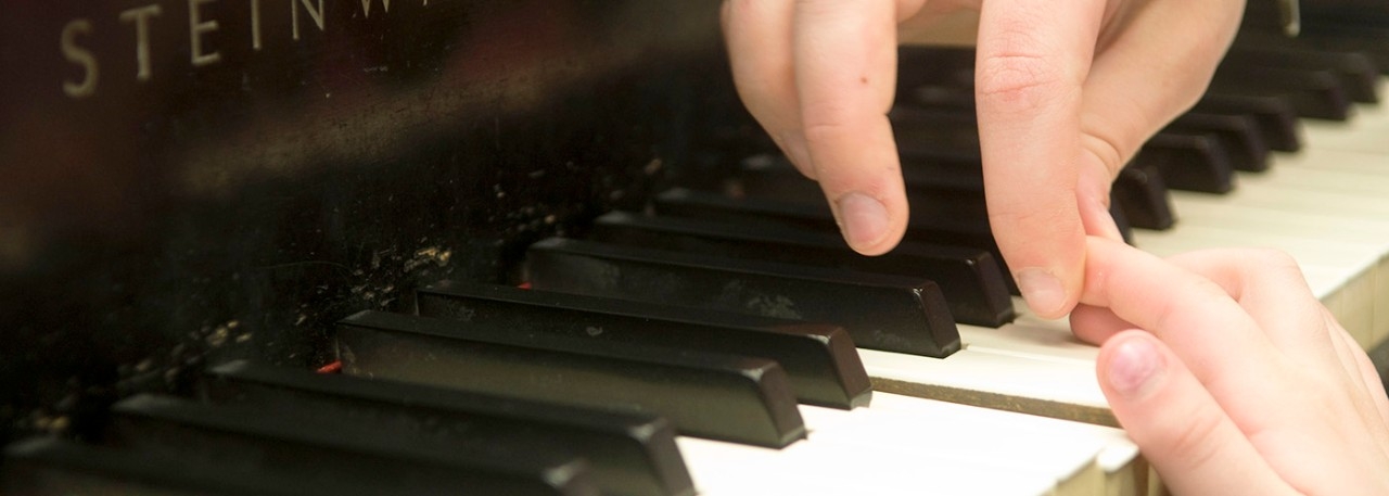 Fingers on piano keys