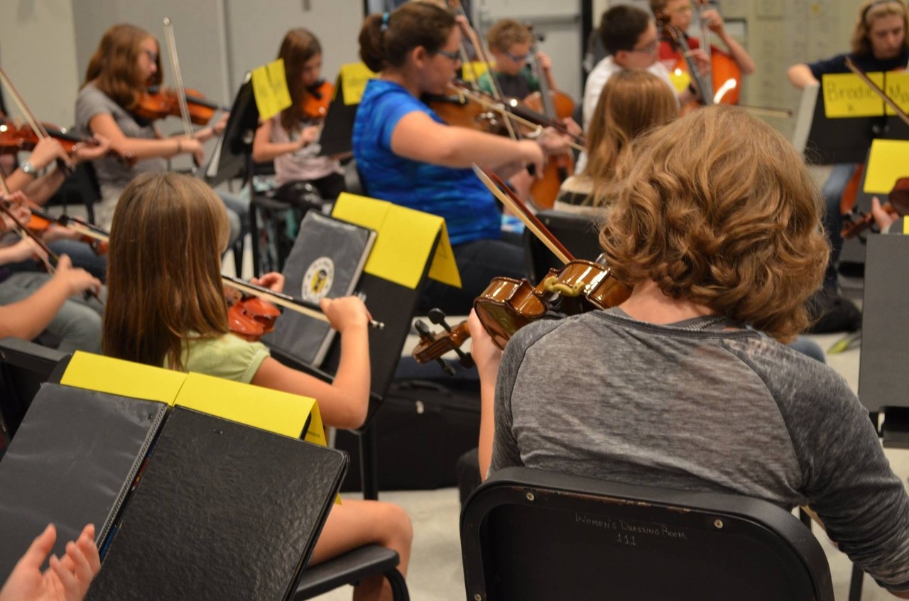 Cello players sitting together