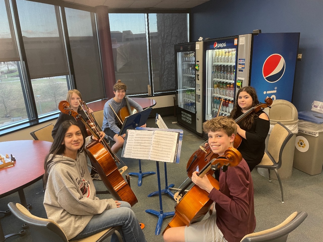Cello players sitting together
