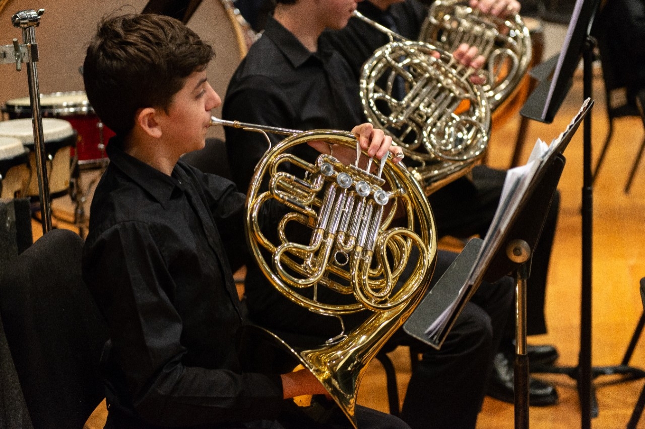 Student playing French horn