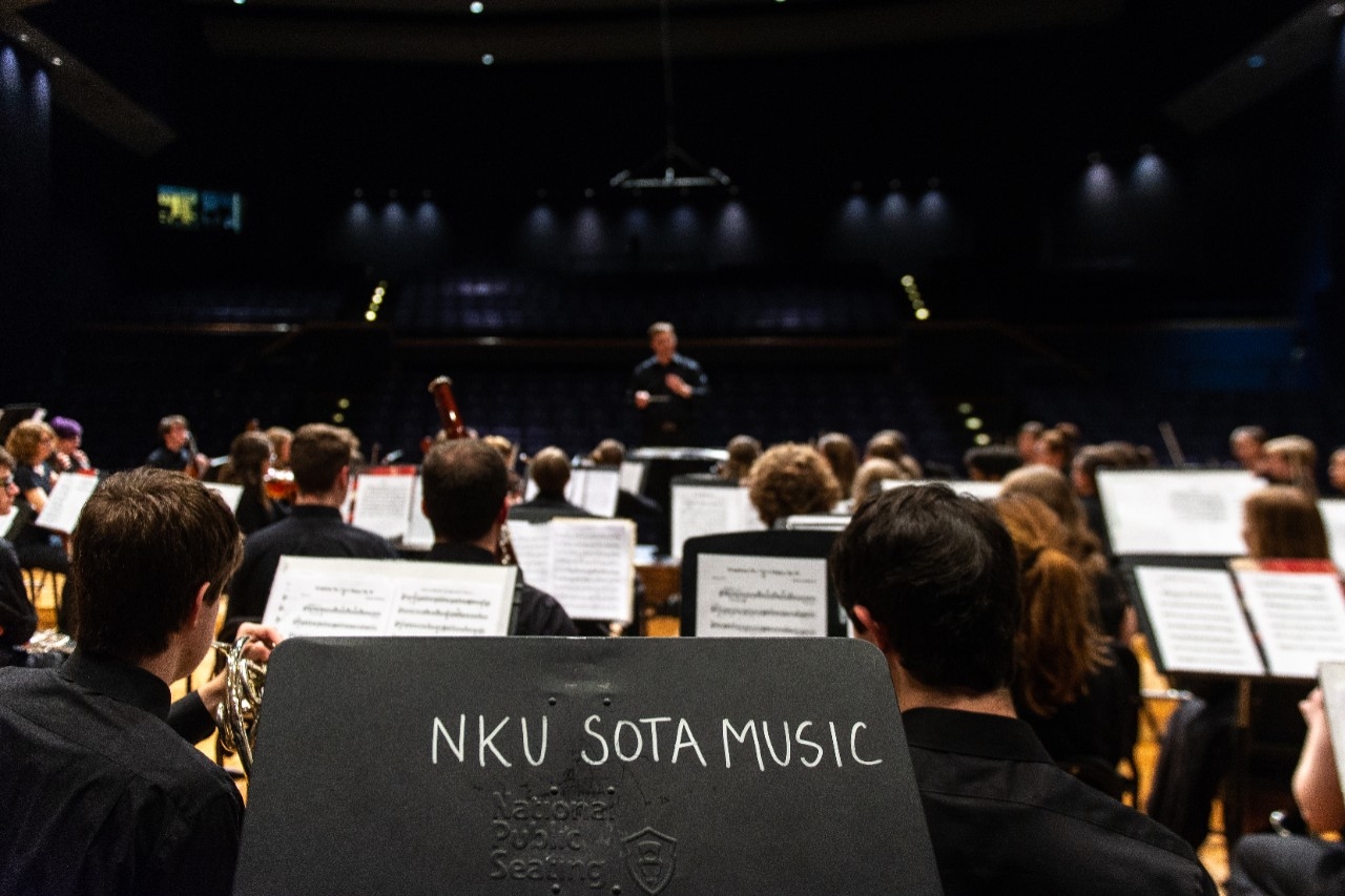 Orchestra students rehearsing on stage