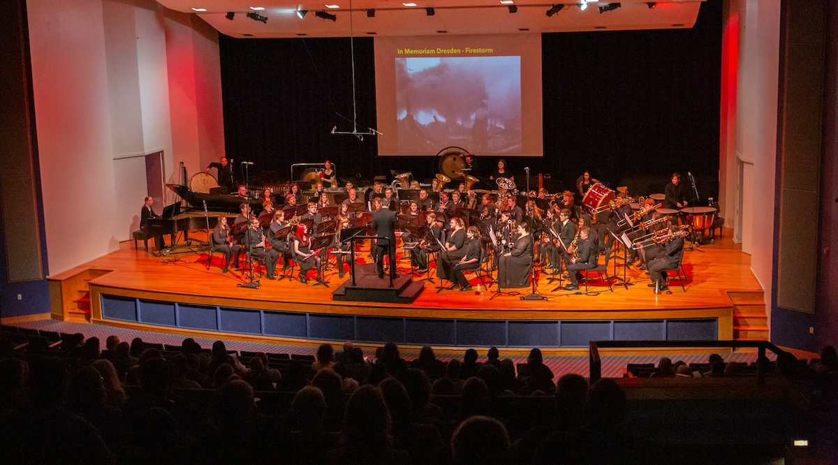 Conductor on stage with wind ensemble