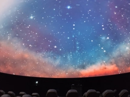 The planetarium screen features a colorful, starry, nebula