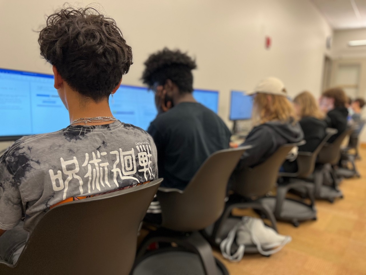 Teens doing computer science activities in a computer lab