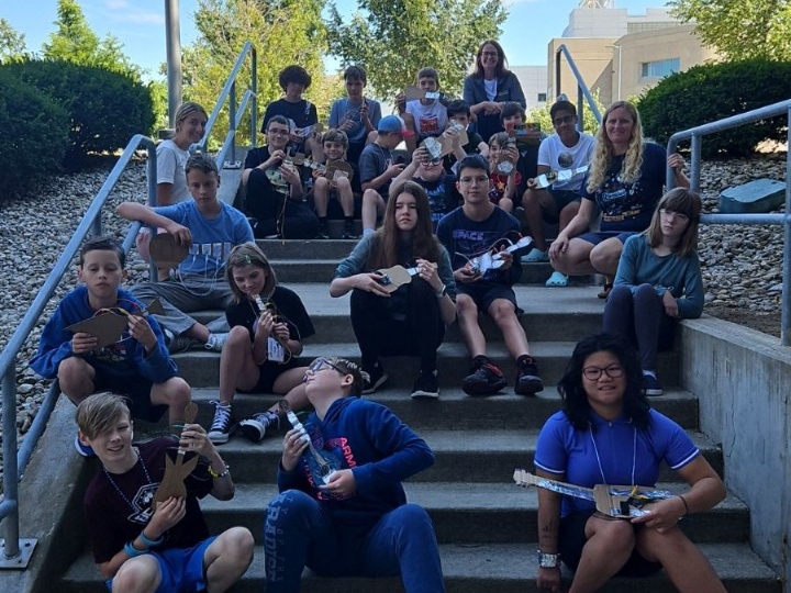 Kids pose for a group photo with their musical creations.