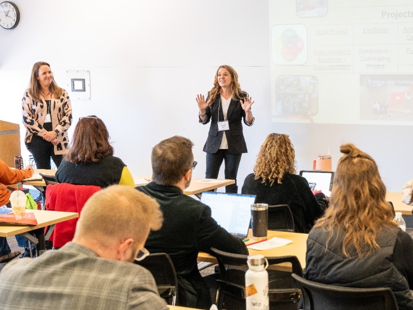 A teacher presents STEM education methods to fellow teachers in a conference setting.
