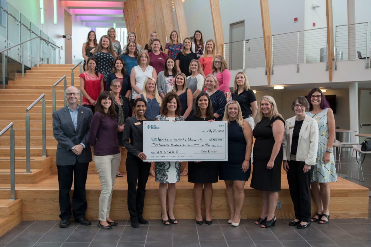 Representatives from the Duke Energy Foundation and members of CINSAM pose for a group picture with a large check from Duke Energy Foundation.