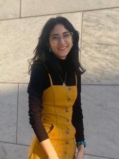 Andrea Cárdenas Echavarría Andrea Cardenas Echavarria smiling in front of a marble wall.