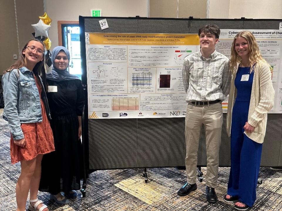 NKU Chemistry and Biochemistry students pose for a picture next to their research poster.