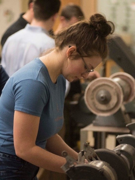 High school student trying out Northern Kentucky University's machine technology during an Engineering Academy
