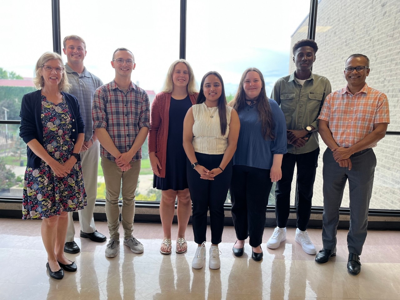 NKU Mathematics and Statistics faculty and student researchers smiling for the camera after their final summer research presentation with a community partner