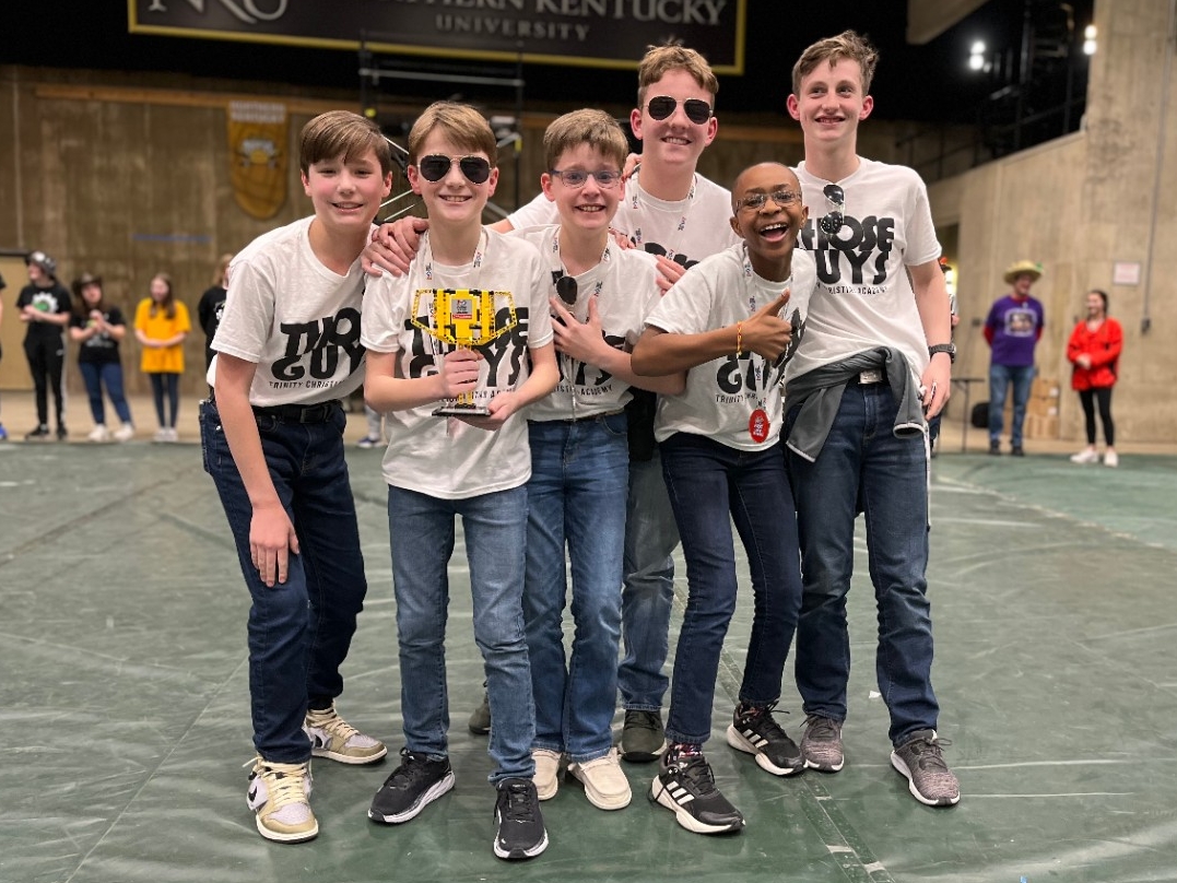 An award-winning team poses enthusiastically for a picture at the FIRST LEGO League Championship Tournament