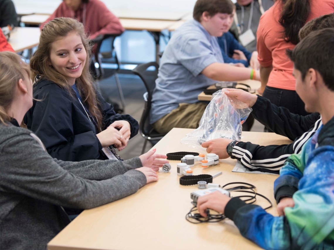 High school students enjoy an engaging STEM activity together at High School STEM+H Day