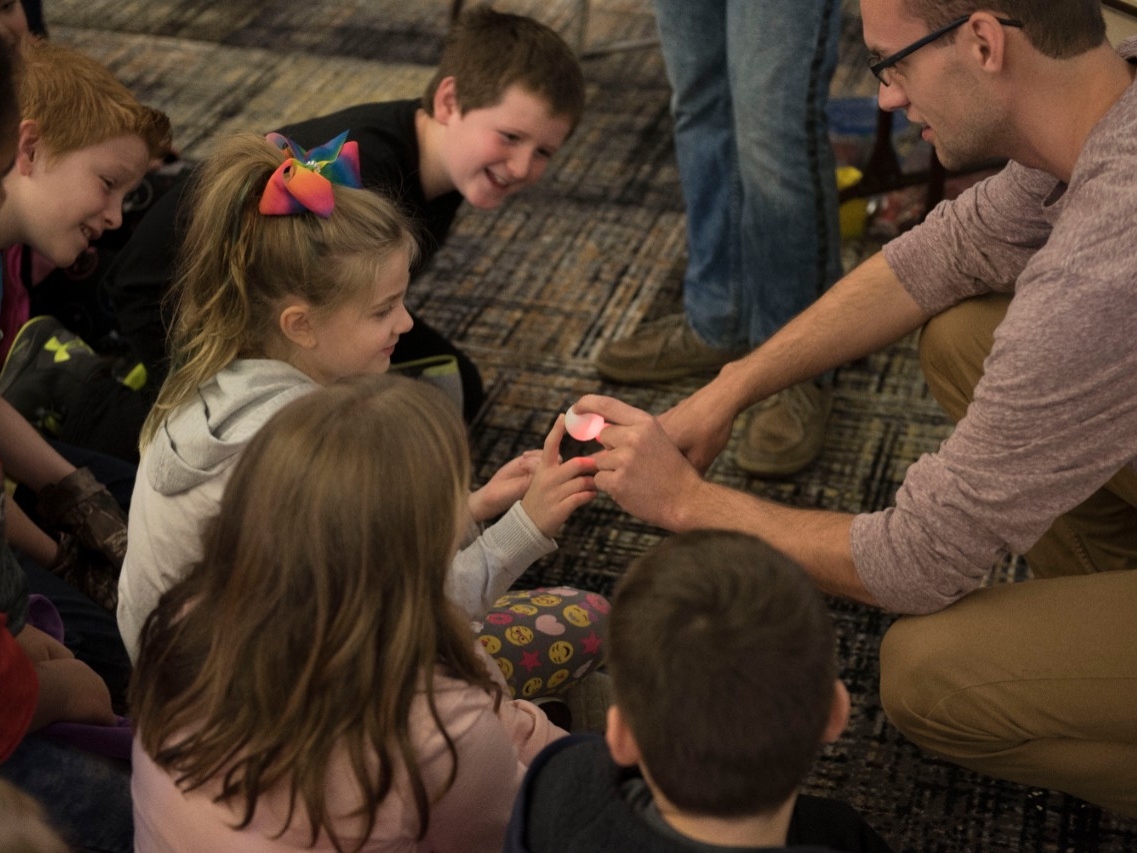 An enthusiastic group of elementary students participating in a STEM experiment at Elementary STEM Day