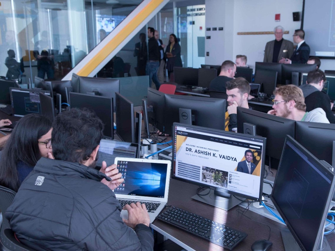Cybersecurity students working at computers in the lab