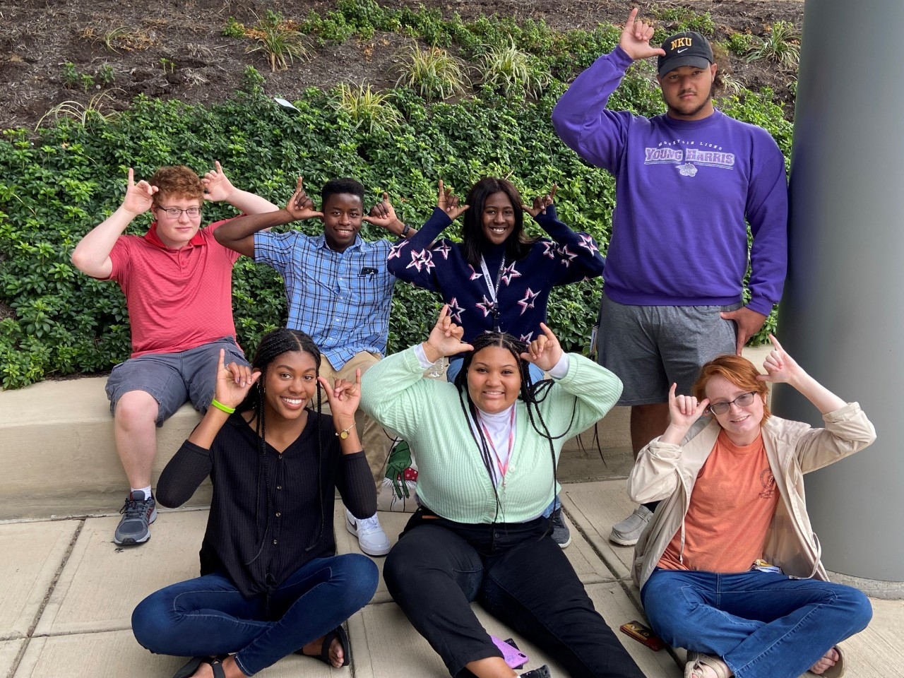A small group of 2021 STEM Ready participants hanging out on Northern Kentucky University's campus, smiling for the camera, and "Norsing it up".