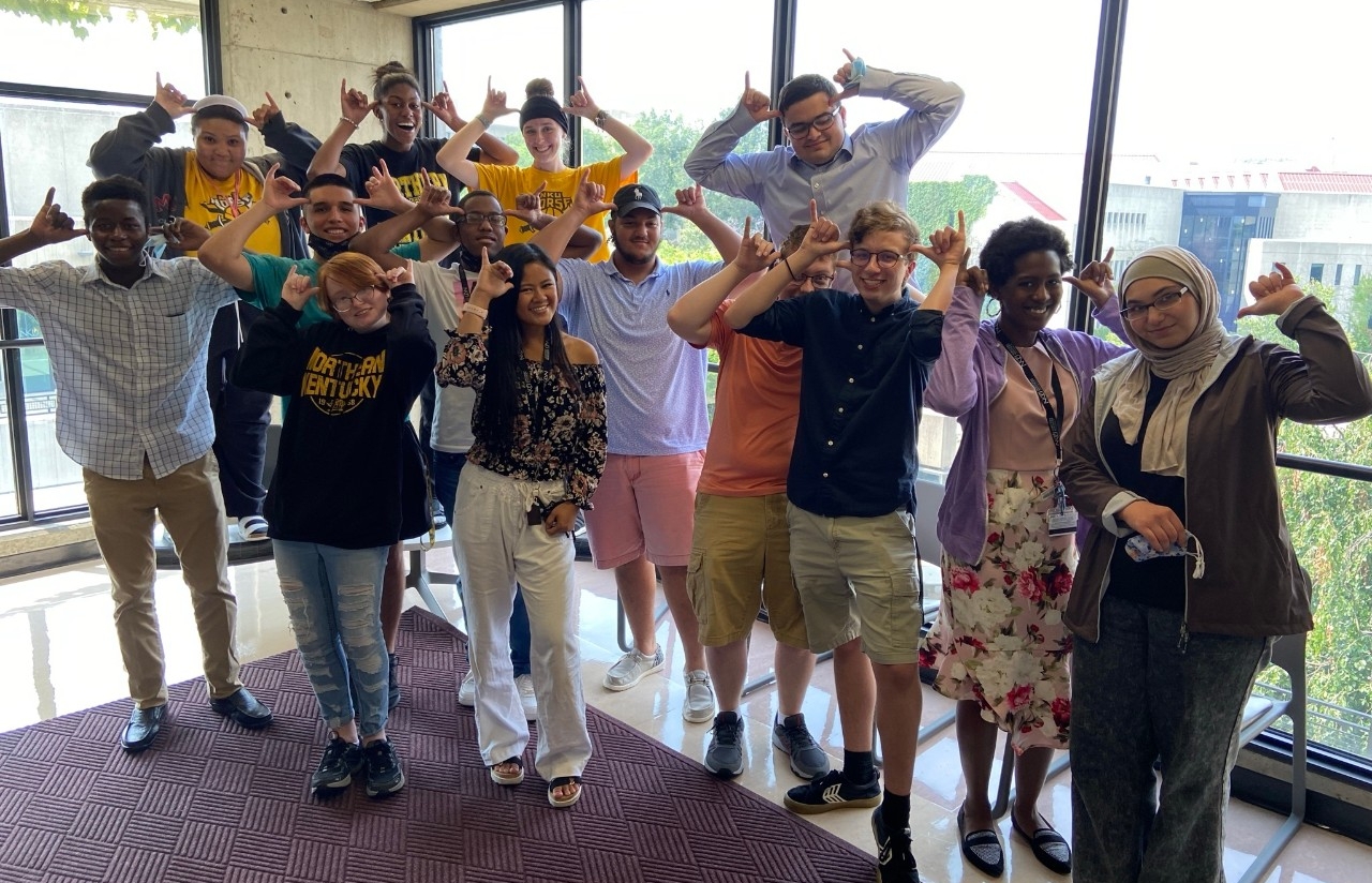 The summer 2021 cohort of STEM Ready / STEM Summer Spark participants smile for the camera making the "Norse Up" hand signal
