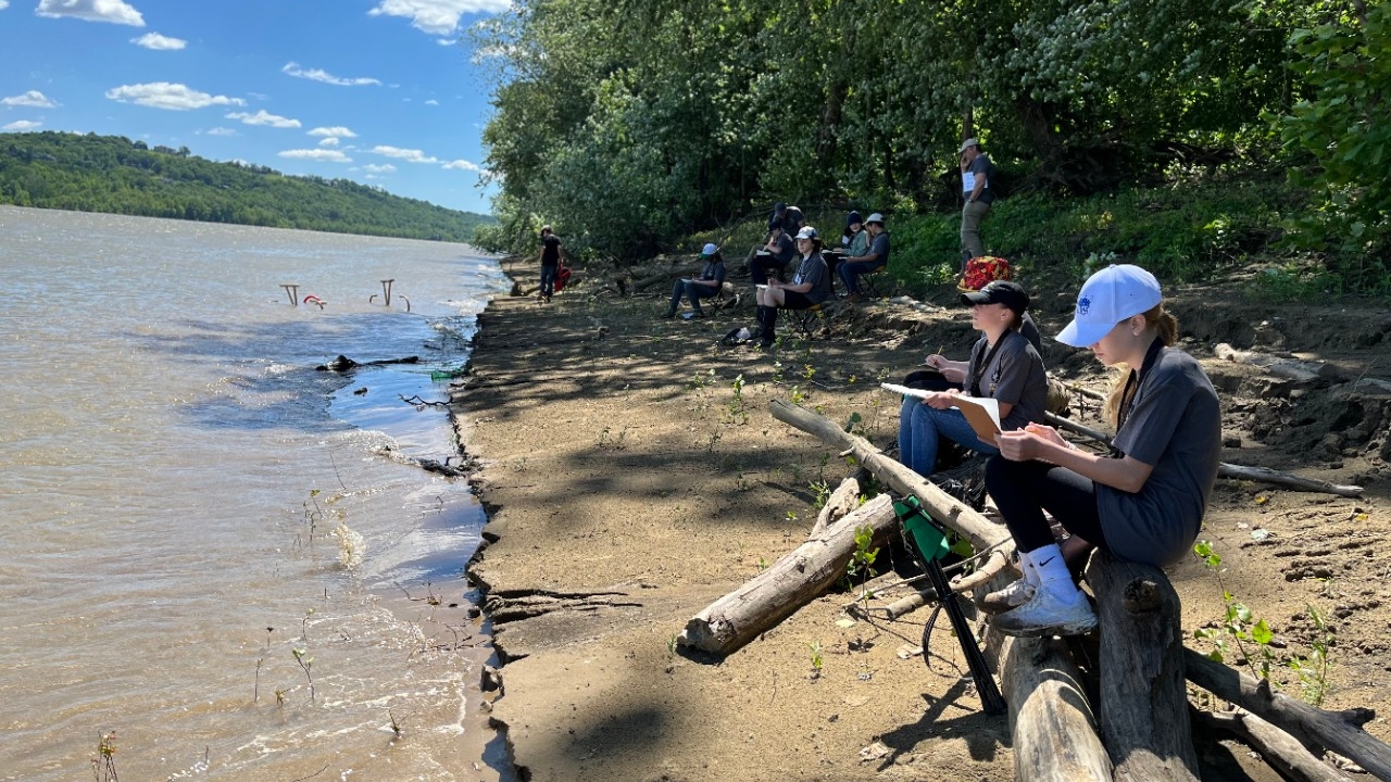 Teens draw their observations on the shores of the Ohio River