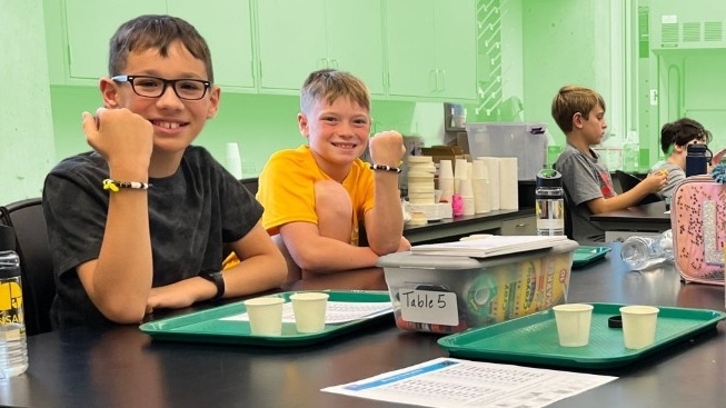 Decorative image of children doing a STEM lesson together