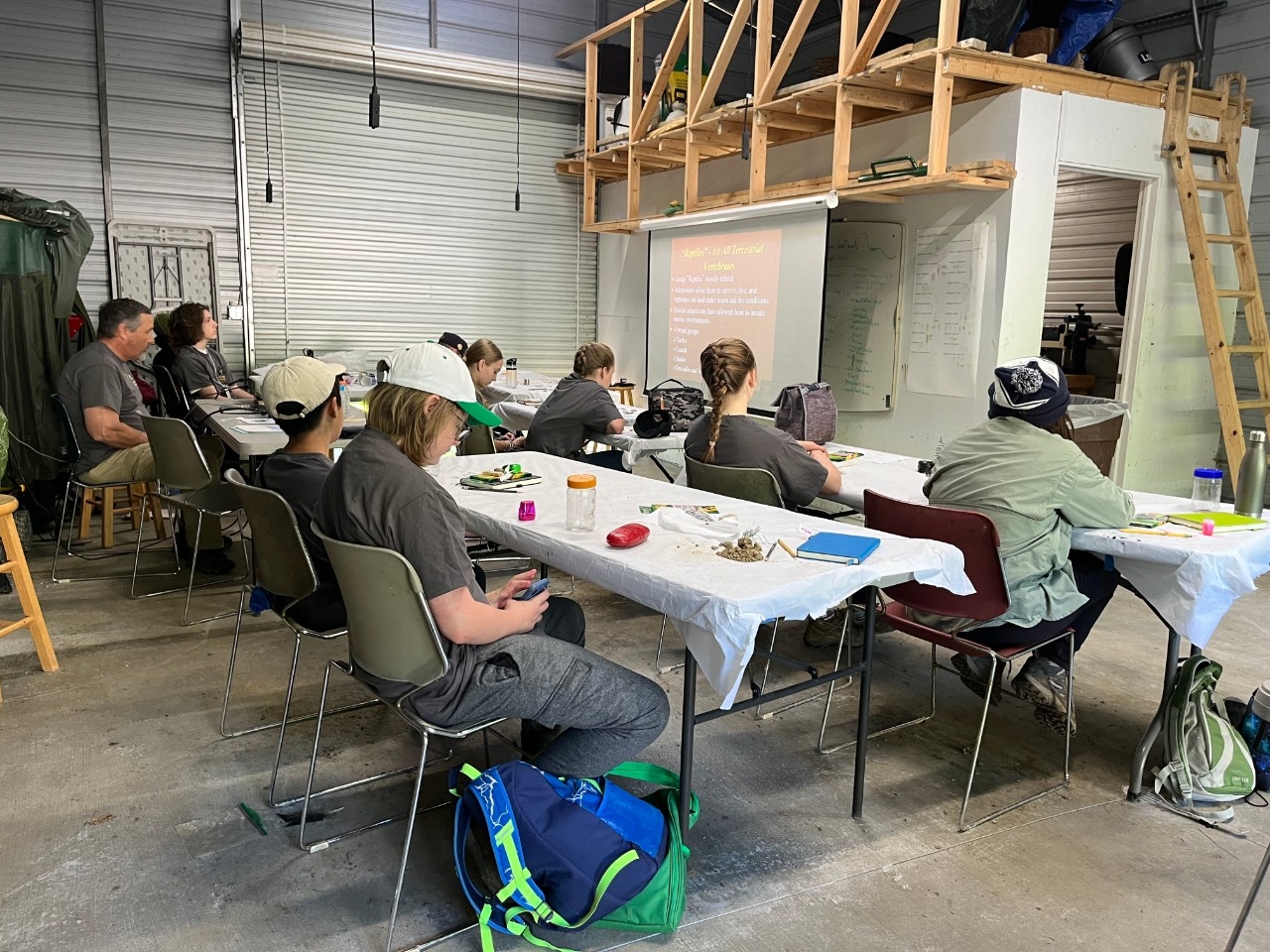 NKU REFS visitors sit a tables in an activity space to learn about environmental biology.
