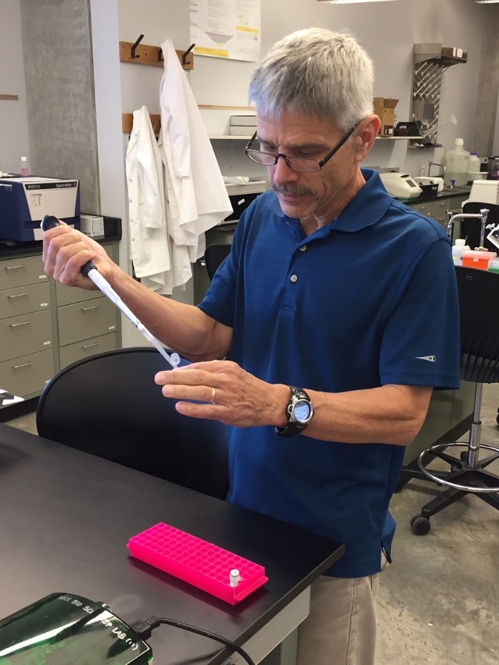 Photo of Dr. Schultheis conducting research in the lab.