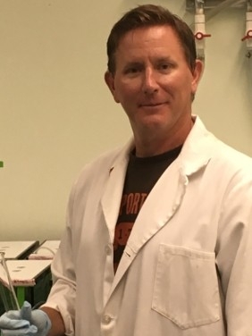 Photo of Dr. Thompson doing research in the lab.