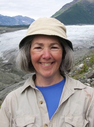 Photo of Dr. Curran with mountains in the background.