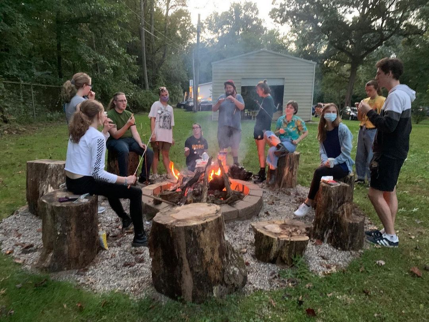 TriBeta members having a bonfire