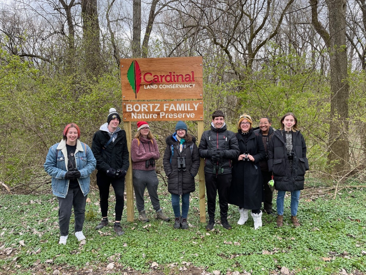 Birding Club members on a bird-watching outing outside on a cold day.