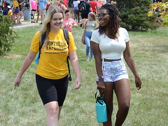 Two students walking together at Northern Exposure event.