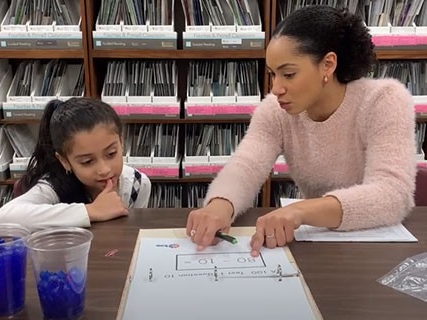 A math teacher uses unique techniques to teach math concepts to a young student