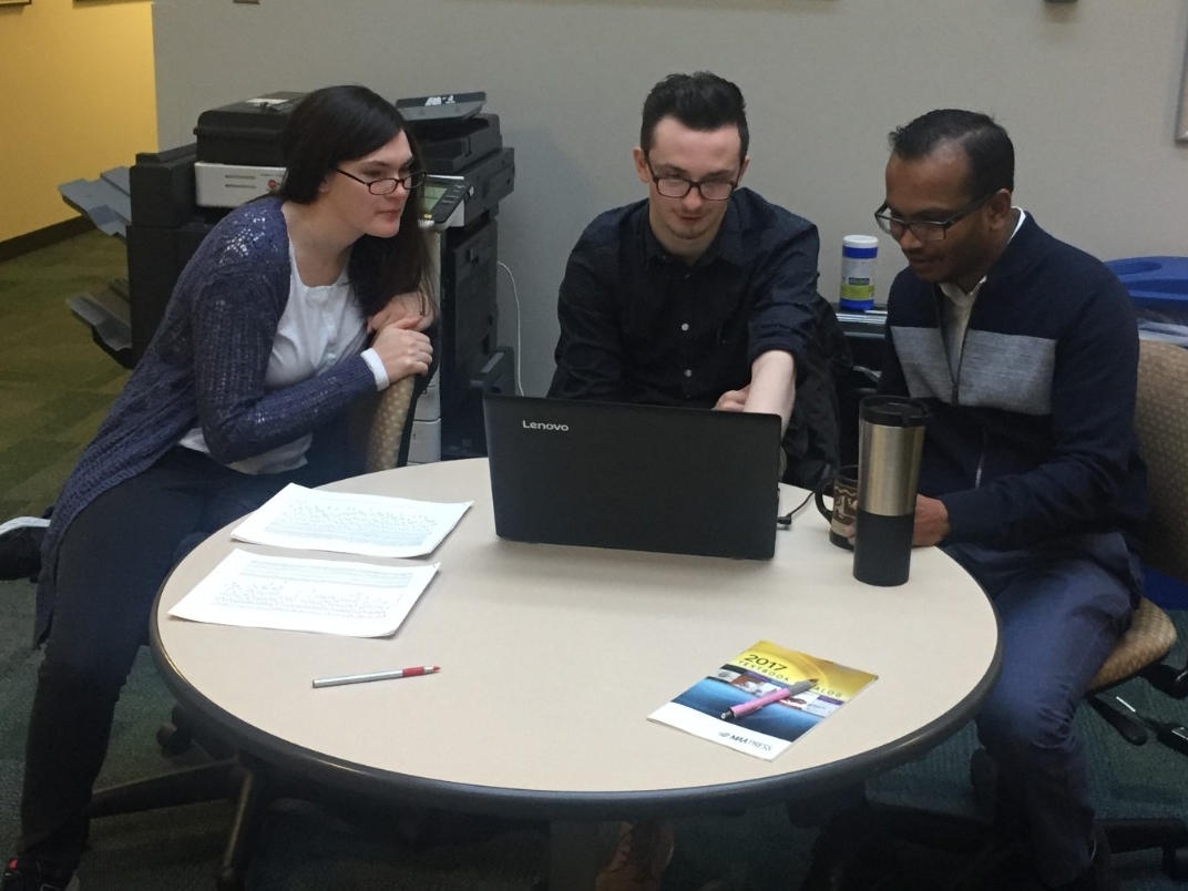 A BCC representative explains statistical analysis to clients about their research.