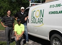 Students standing near a van with an "Icon Solar" Logo