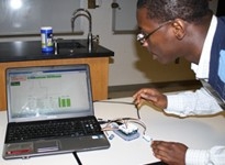 A student examining data from a device hooked up to a laptop