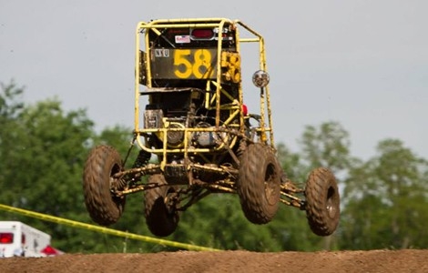 The SAE Baja vehicle mid-jump, about a foot in the air