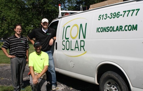 Three students standing near a van with the Icon Solar logo on its side