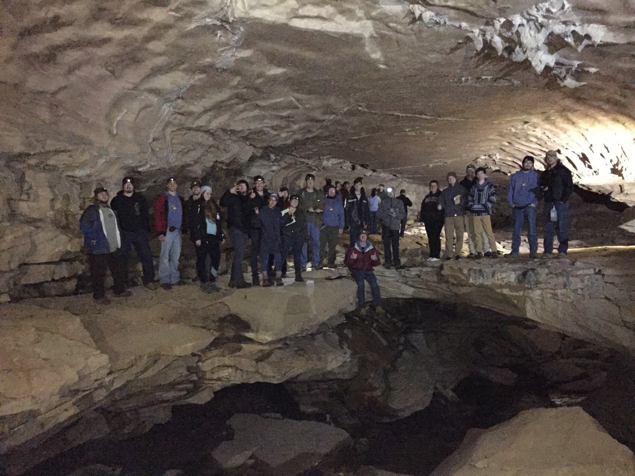 A group of students posing inside Carter Caves